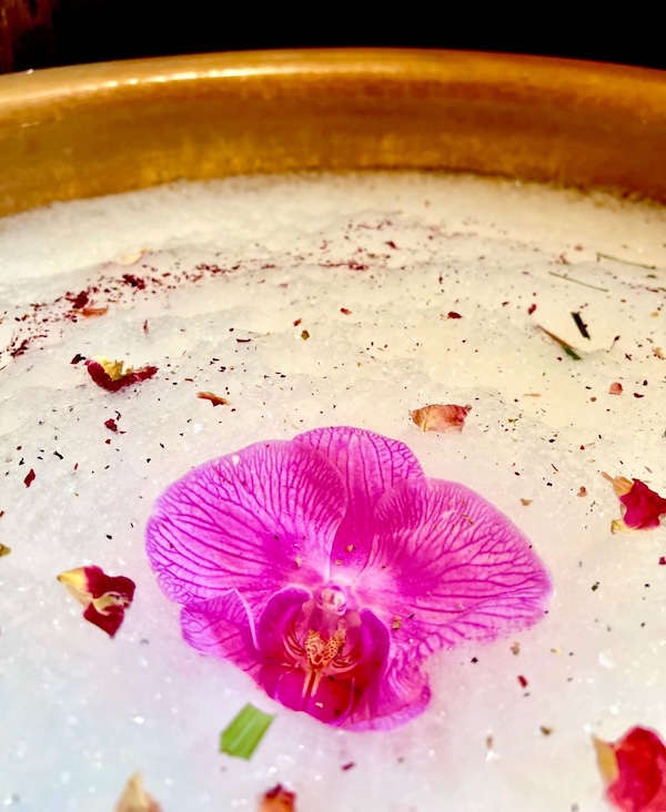 a cooper bowl with forthy top and flower for foot soaks