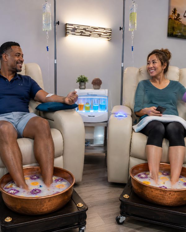 A couple enjoys a professional foot soak while getting Neurostrive med spa service